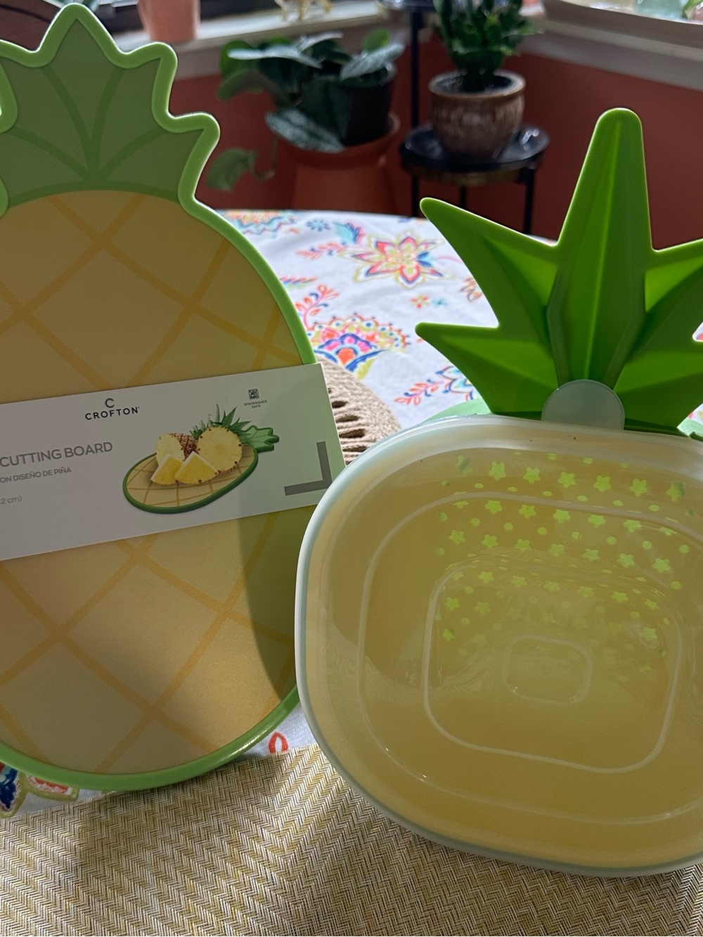 Croton Pineapple-Shaped Cutting Board in Yellow with Green Trim and Colander.